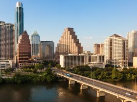 A bridge over a body of water with a city in the background