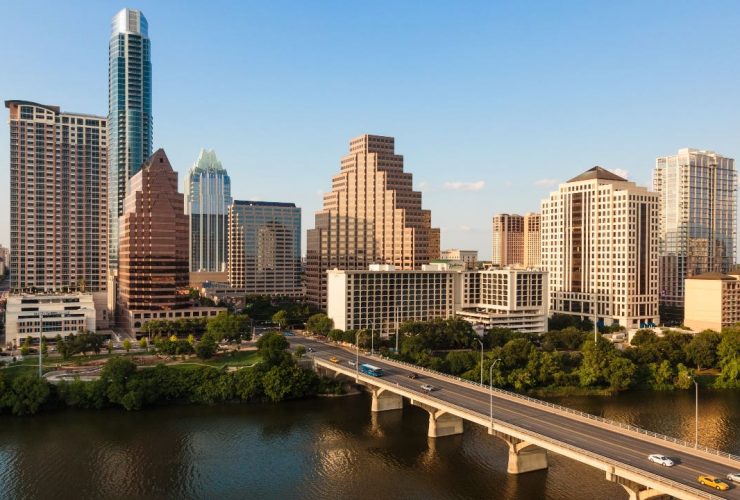 A bridge over a body of water with a city in the background