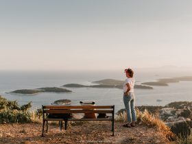 A person sitting on a bench next to a body of water